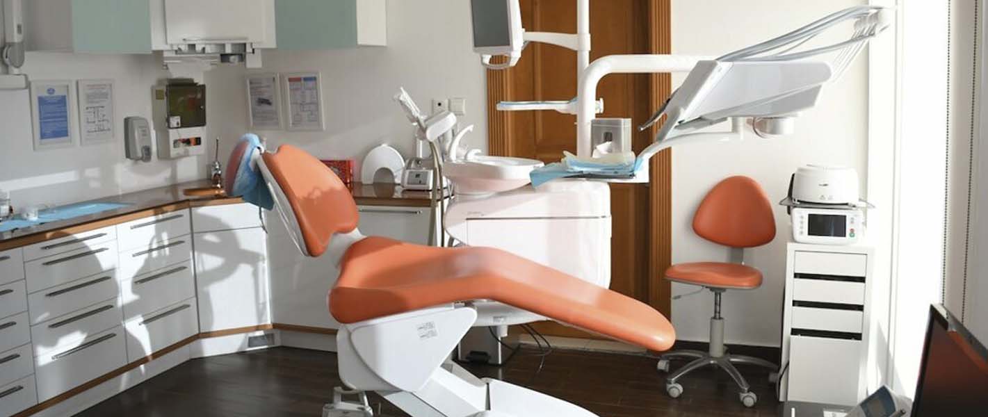 Modern dental chair and equipment in a bright clinic